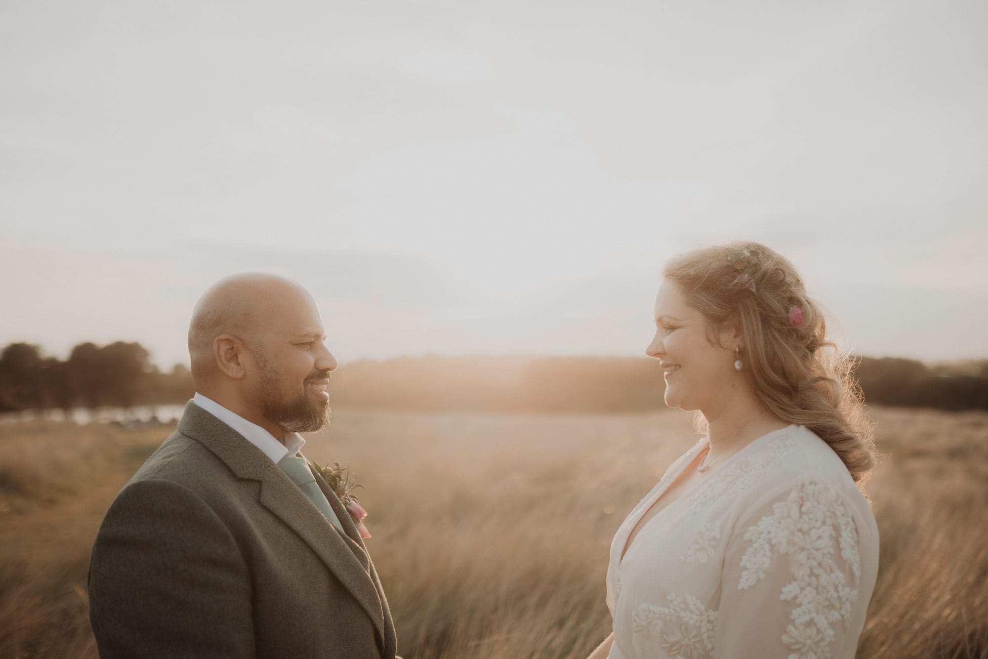 Golden-hour couple portrait in a field