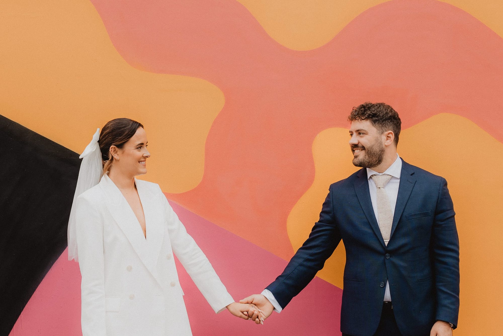 Couple portrait against a colourful mural