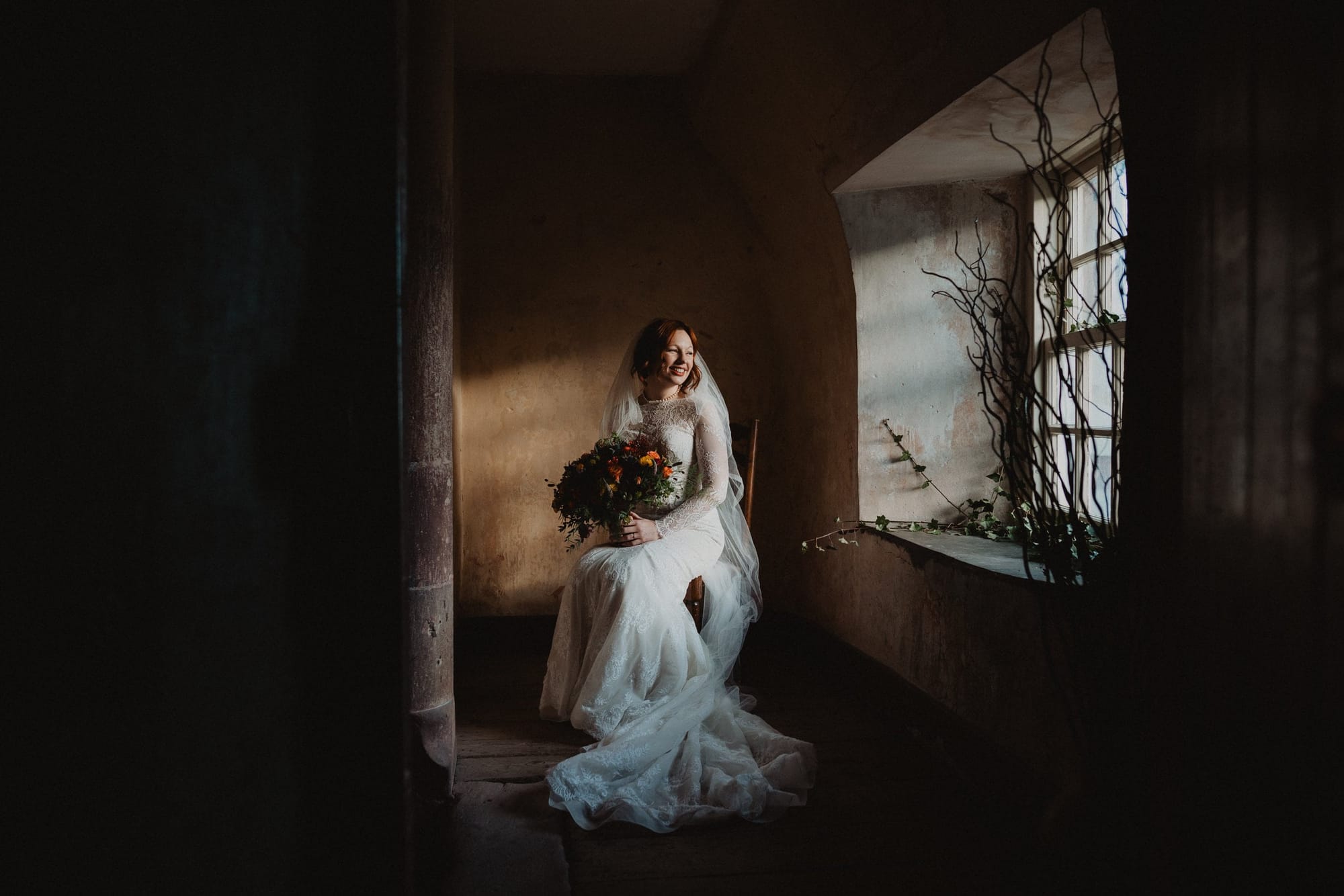 Moody window-lit bridal portrait